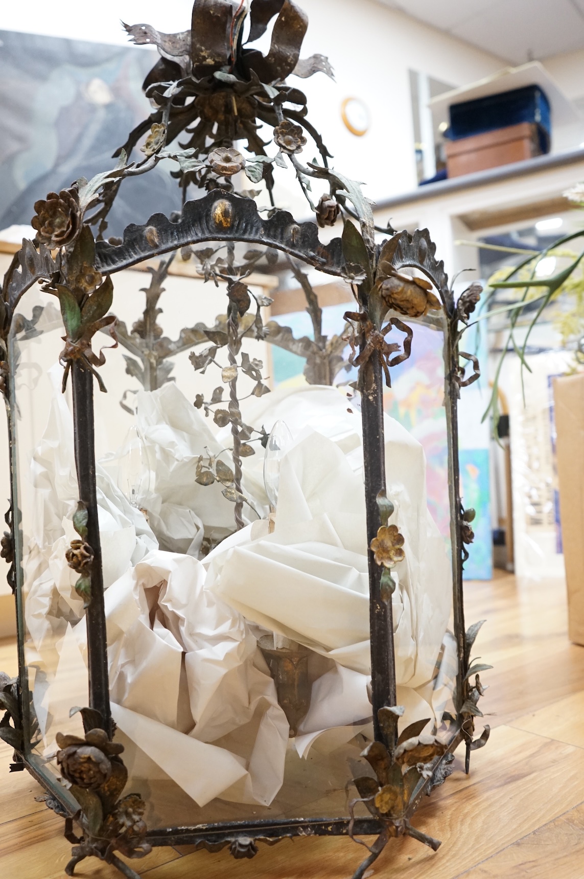 A large French painted wrought iron decorative floral and swagged hexagonal hall lantern, 84cm high